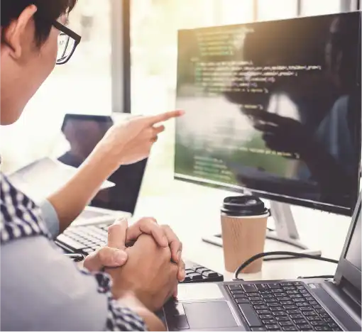 a person pointing at a computer screen